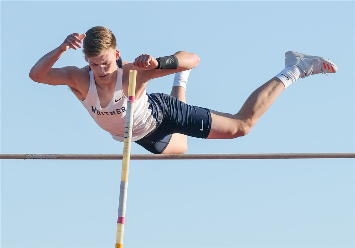 Whitmer senior pole vaulter Ben Scharf clears the bar during the Eastwood R...