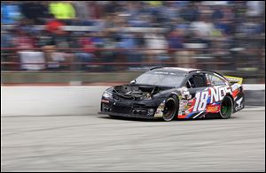 Riley Herbst rounds the corner after his car lost its hood during the Menards 200.