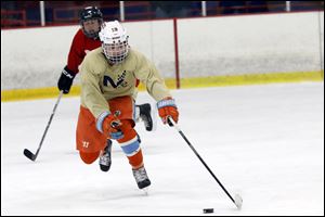 Ben Schoen pushes the puck up the ice during a game at Tam-O-Shanter in Sylvania. The Maumee native played for Detroit youth power Little Caesars last season.