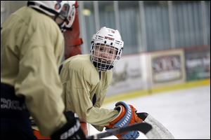 Ben Schoen jokes with a teammate as they wait to hit the ice.