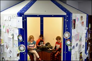 Students read inside a ballistic shelter designed to protect them from school shooters and tornadoes, in the corner of a classroom at Healdton Elementary School in Healdton, Okla.