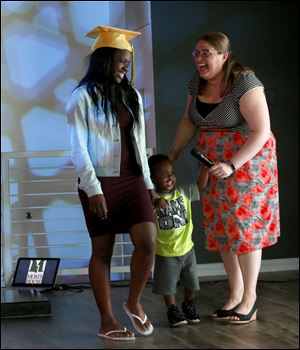 Start High School and Mom's House graduate Reginae Jones, with her son Rylin, is greeted by program director Julie Haas.