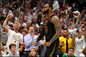LeBron James of the Cleveland Cavaliers reacts after a basket in the fourth quarter against the Boston Celtics during Game 6 of the NBA Eastern Conference finals.