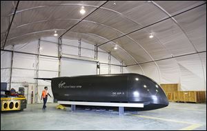 David Israel, director of Content and Digital Product at Virgin Hyperloop One, walks to the rear of the Virgin Hyperloop One ‘cargo’ pod at the testing facility in Apex, Nev.