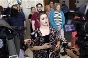 Laura Shaffer, center, addresses members of the media as she and a dozen other residents of the Old West End prepare to attend the May 31st Toledo City Council meeting of the Neighborhoods, Community Development and Health Committee at One Government Center in downtown Toledo.