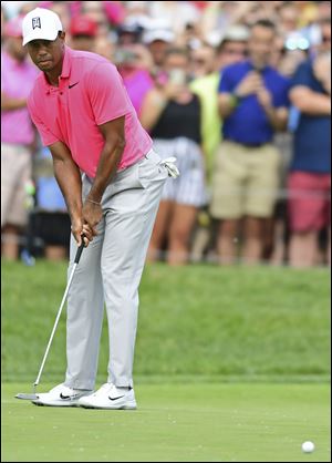 Tiger Woods putts on the 18th hole.