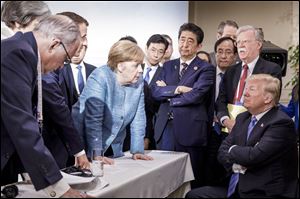German Chancellor Angela Merkel, center, speaks with President Trump, seated at right, during the G7 Leaders Summit in La Malbaie, Quebec, Canada, on June 9.