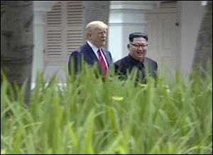 North Korean leader Kim Jong Un, right, walking with U.S. President Donald Trump in the garden during their summit in Singapore on June 12.