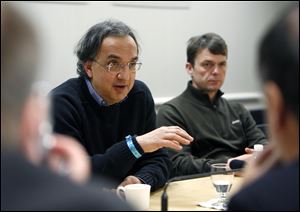 Chrysler CEO Sergio Marchionne, left, with Jeep brand CEO Mike Manley to his right, speaks to reporters during a roundtable discussion at the North American International Auto Show at Cobo Center in Detroit in November, 2010.