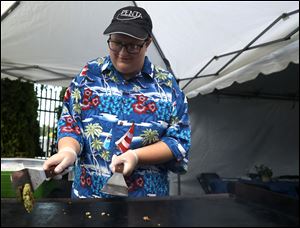 Beccah Cowell prepares a falafel in the backstage area before the Beach Boys’ July 18 concert at Centennial Terrace.