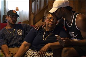 From left to right: C.J. Kulwicki, 23, cousin, Alfreada Radford Tucker, 67, grandmother, and Tre'Von Richardson, 24, brother, console each other as they talk about their family member, Lamar Richardson.