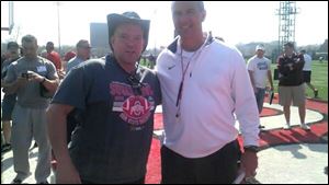 Ohio State fan Jeff Hamms, left, with head coach Urban Meyer at a prior event. Hamms has organized a rally for the embattled coach Monday on campus.