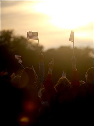 Fans wave American flags as the sun sets during last year's Bash On The Bay country music festival in Put-in-Bay, Ohio.