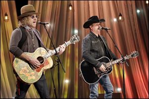 Kenny Alphin, left, and John Rich, right, of the country music duo Big & Rich, perform in 2016 in Nashville.