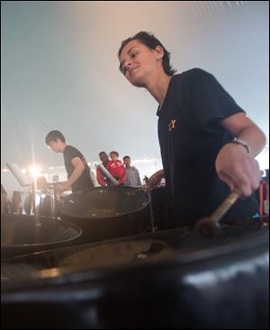 A Toledo School for the Arts student plays with Glass City Steel Drum band in a past performance. The Community Steel Drum Band is open to all high school and college-age students, with no audition or experience required.