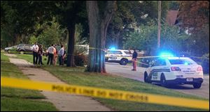 Police work the scene of a shooting at West Delaware and Glenwood avenues in the Old West End on Tuesday.