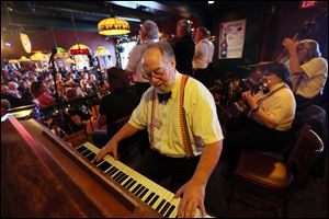 'Ragtime Rick' Grafing plays the piano for the Cakewalkin' Jass Band, one of the many bands performing at Grugelfest in Perrysburg, which begins Friday.