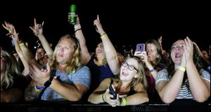 Fans cheer as Lee Brice performs during The Blade's 35th annual Northwest Ohio Rib Off on August 18 at the Lucas County Fairgrounds in Maumee, Ohio.