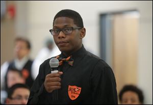 Monjuan Walker, a member of Young Men of Excellence (YMOE) and a senior at Bowsher High School, asks a question during the conference. 