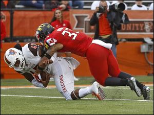 Maryland's Tre Watson takes down Bowling Green's Dorian Hendrix during Saturday's game at Doyt Perry Stadium. Maryland won the game, 45-14, after trailing at halftime.