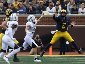 Michigan quarterback Shea Patterson throws for a first down during the team's win vs. Western Michigan on Saturday.