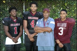 From left Scott High School football players Javon Johnson, Lawrence Kynard, head coach Mark Weaver, and Jamie Johnson have the Bulldogs off to their best start since 1986. They'll play at Akron Kenmore-Garfield on Saturday.