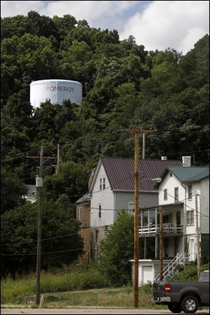 A tower bearing the name of Pomeroy overlooks a church and several homes near the city's downtown.