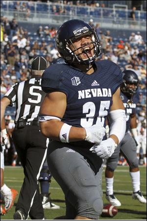 Nevada running back Toa Taua celebrates his first quarter rushing touchdown against Oregon State during Saturday's game in Reno, Nev.