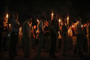 In this Aug. 11, 2017, file photo, multiple white nationalist groups march with torches through the University of Virginia campus in Charlottesville, Va. 
