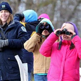 In this file photo from December, 2016, left to right: Ashley Smith, Vera Davis, and Emma Ferrell look at a group of gulls on the Maumee River during the annual Christmas Bird Count at Farnsworth Metropark in Waterville, Ohio.