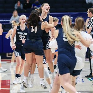 Napoleon players celebrate defeating Dayton Carroll, 46-43,  in a Division II state semifinal girls basketball game Friday, March 12, 2021, at the University of Dayton Arena in Dayton.  (THE BLADE/JEREMY WADSWORTH)