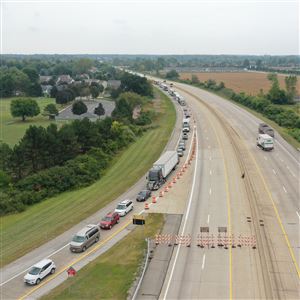 Backed up traffic, including numerous tractor trailers, works its way through the M-50 exit from northbound U.S. 23 in Dundee, Mich., as seen from a drone Sept. 13, 2021.