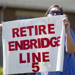 Lauren Sargent takes part in a protest before the Enbridge Line 5 pipeline public information session in Holt, Mich.