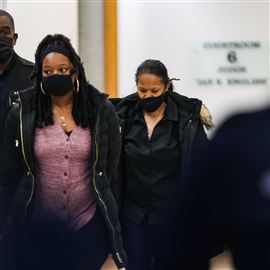 Dajnae Cox, left, and Bobbie Johnson, the mother and grandmother of Braylen Noble, walk out of Judge Ian English’s courtroom in handcuffs after their arraignment at the Lucas County Courthouse in downtown Toledo on November 16, 2021.