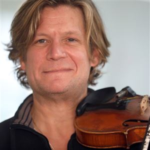 Alex DePue holds his violin in the Wolfe Center for the Performing Arts in Bowling Green State University on Dec. 3, 2018.