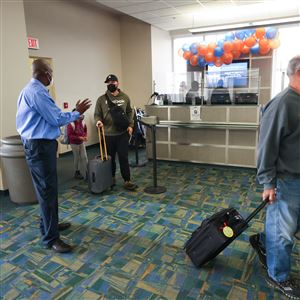 Thomas Winston, president and CEO of the Toledo-Lucas County Port Authority, greets passengers arriving at the Eugene F. Kranz Toledo Express Airport on the first Allegiant Air flight from Phoenix-Mesa Gateway Airport March 9 near Swanton. 