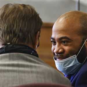 Ronnie Nelson, who is on trial for shaking his infant niece to death, consults with his lawyer David Klucas during opening statements at the Lucas County Courthouse in Toledo.
