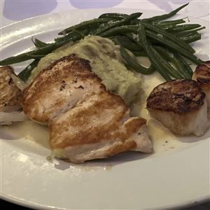 The mixed grill at Mancy's Bluewater Grille in Maumee features blue cod, salmon, and scallops with creamy leek mashed potatoes and baby green beans.  