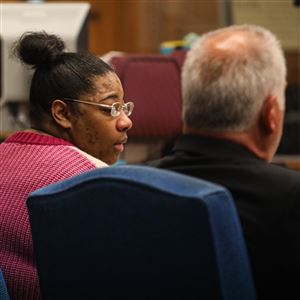 Sharonda Tuggle, 31, listens to witness testimony during her trial Monday at Lucas County Common Pleas Court in Toledo.