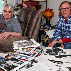 Blue Suit Records co-founders John Rockwood, left, and Bob Seeman are photographed among vinyls, cassettes, and posters on Tuesday, at Rockwoodu2019s apartment in Toledo. 