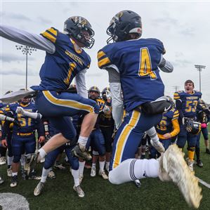 Whitefordu2019s Shea Ruddy, left, and Hunter DeBarr celebrate their 44-6 win over Clarkston Everest in the Division 8 state football semifinal at Woodhaven High School in Brownstown, Mich., on Saturday November 19, 2022. THE BLADE/REBECCA BENSON (THE BLADE/REBECCA BENSON)