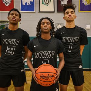Varsity basketball players, from left, Jerome Bush, Deyontae Spearman, and Stone Edwards attend Start High School in Toledo on Monday.