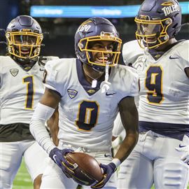 University of Toledo WR Demeer Blankumsee (0), celebrates scoring a touchdown against Ohio University with teammates Jerjuan Newton, left, and Jamal Turner, right, Dec. 3, at Ford Field in Detroit, Michigan.