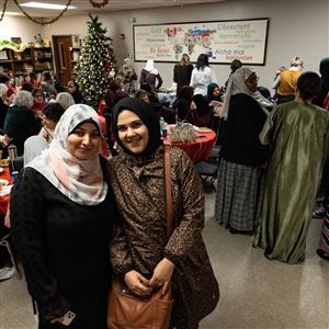 Workforce Development Program graduates Sara Selim and Nashwa Elsayed attend the end-of-the-year graduation celebration at Water For Ishmael in Toledo, on Thursday. (THE BLADE/STEPHEN ZENNER)