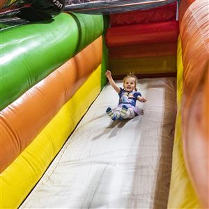 Londyn Segrist, 4, slides down the inflatable slide at Sylvania Playland in Sylvania on Jan. 6. (THE BLADE/REBECCA BENSON)