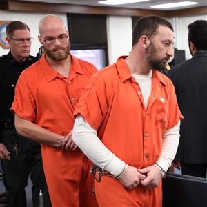 Charles Walker , left, and Brent Kohlhofer are escorted from court following their arraigned in Lucas County Common Pleas Court, January 10, in Toledo. 