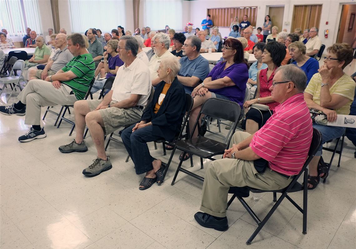 People listen at a Block Watch meeting.