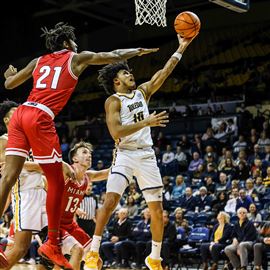 Toledo Rockets guard RayJ Dennis best to the opposite side of the rim against the Miami Redhawks in a MAC menu2019s basketball game on Feb. 14 at John F. Savage Arena in Toledo.