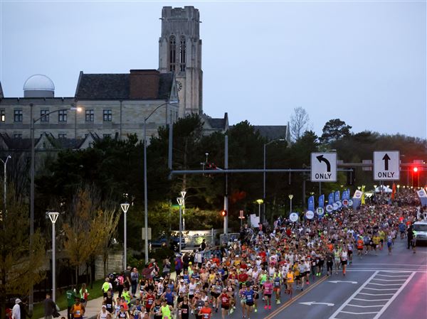 Supporters cheer on Glass City Marathon runners
