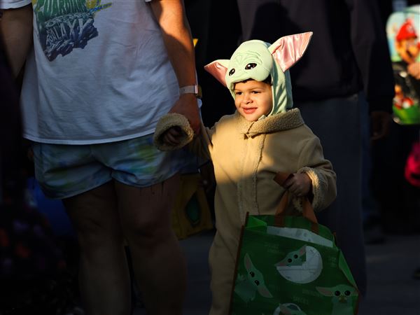 Dressed as Baby Yoda, two-year-old Quill Jeffreys waits in line during 4th annual Lucas DD Trunk or Treat at the Lucas County Board of Developmental Disabilities in Toledo on Oct. 14.